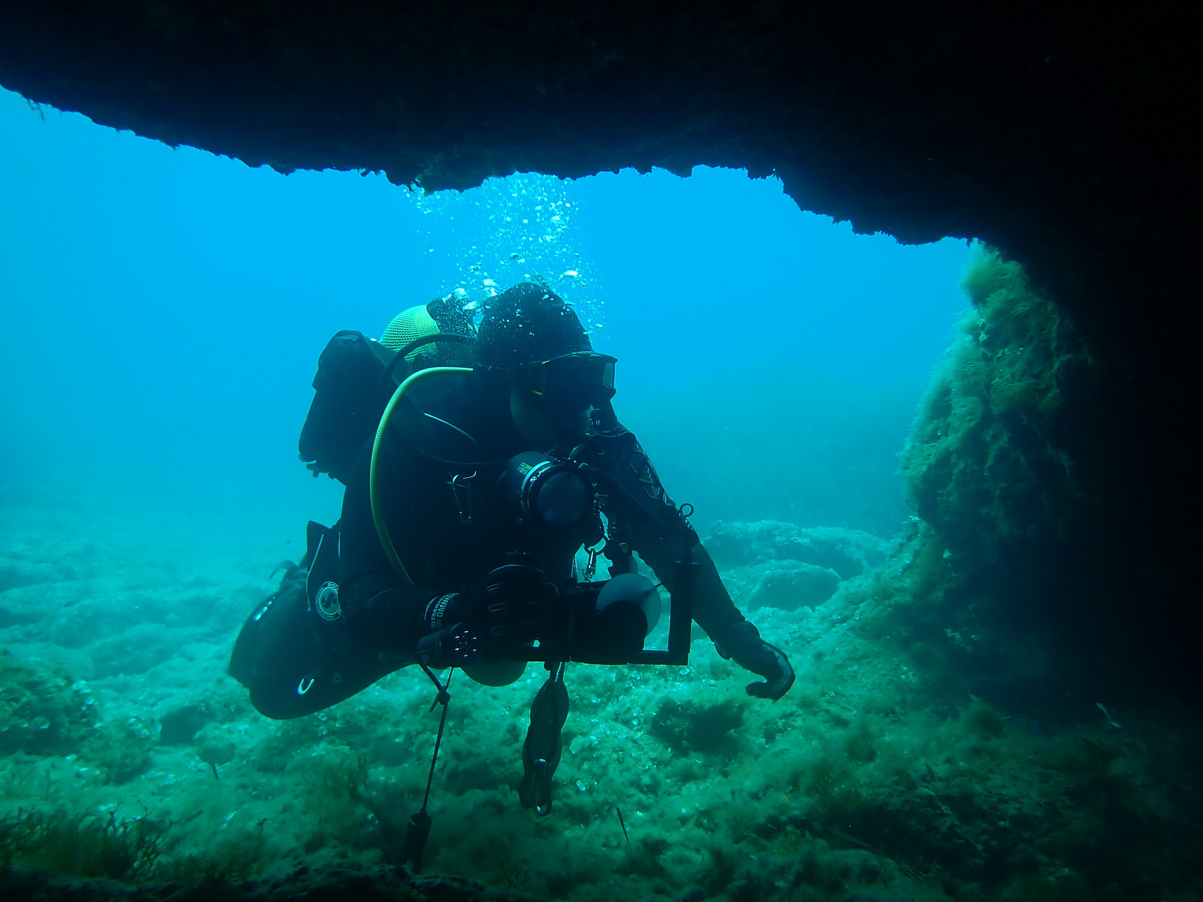 A scientific diver documenting a marine cave in the Greek seas